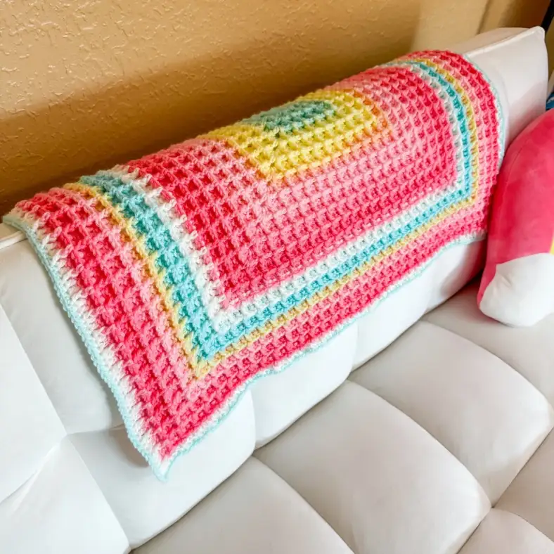 Close up of a crocheted blanket made with the waffle stitch in a square